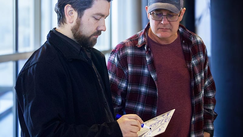 two employees working through some manual business proceses